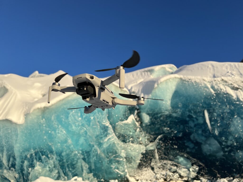 Image of a drone flying over a glacier