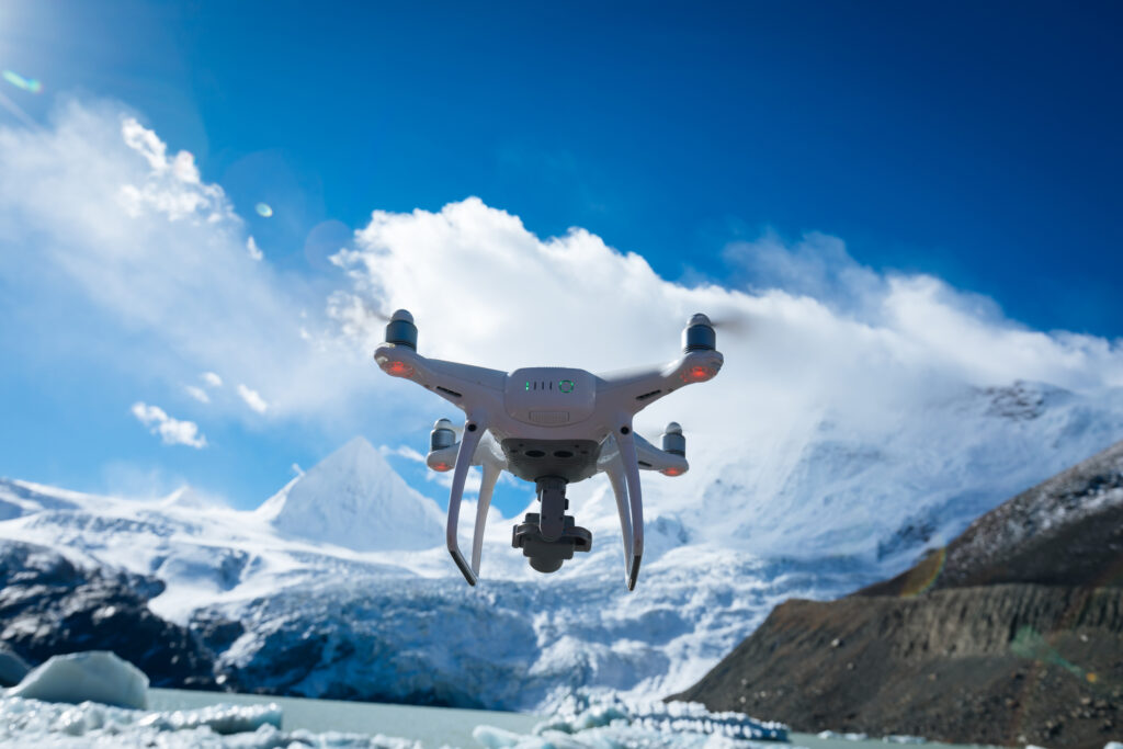 Image of a drone flying over a mountain